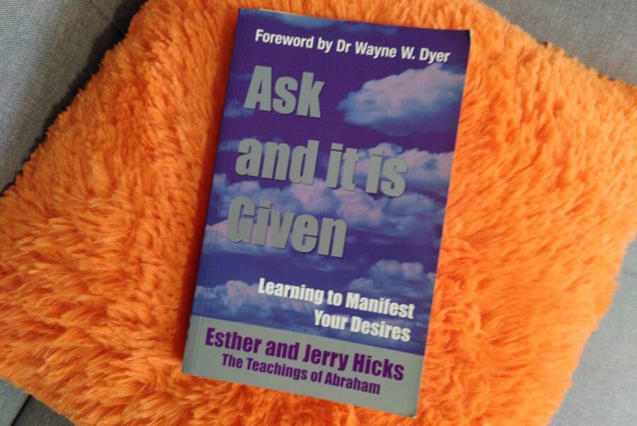 Picture of the book ask and it is given sat on a fluffy orange cushion