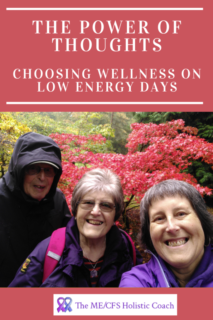 a woman with her elderly parents in front of a beautiful tree